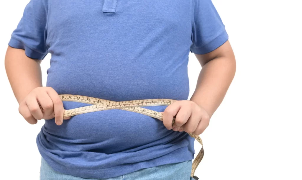 A guy measuring his waist- Peanut Butter Blog