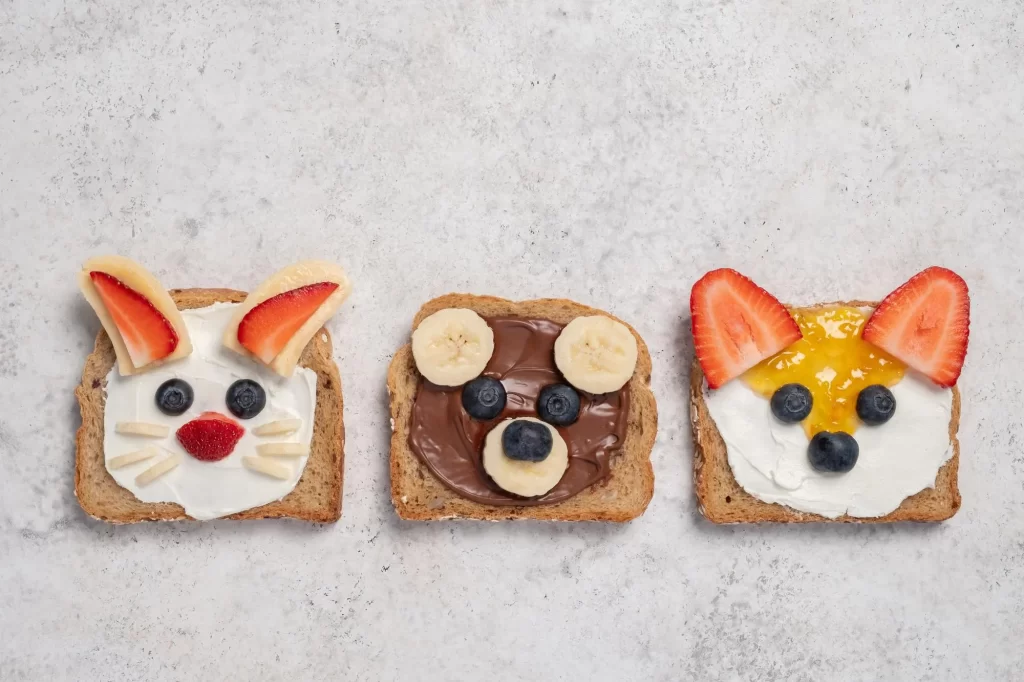 Three cute faces on breads made with cream cheese and fruits- Cream Cheese Recipes