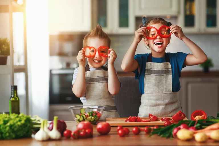 Two kids smiling holding veggies in hands- Cream Cheese Recipes